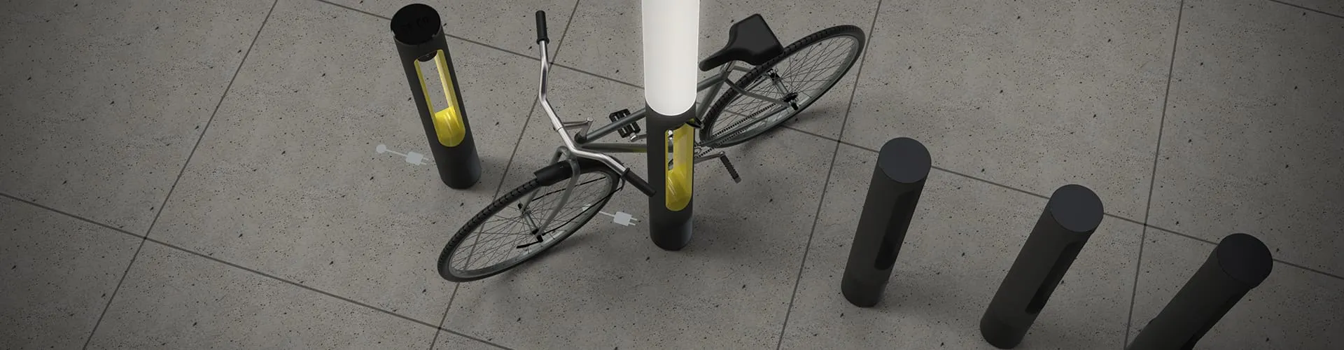 Wide overhead view of a bicycle secured at a SMARTPOLE charging station surrounded by plain bollards