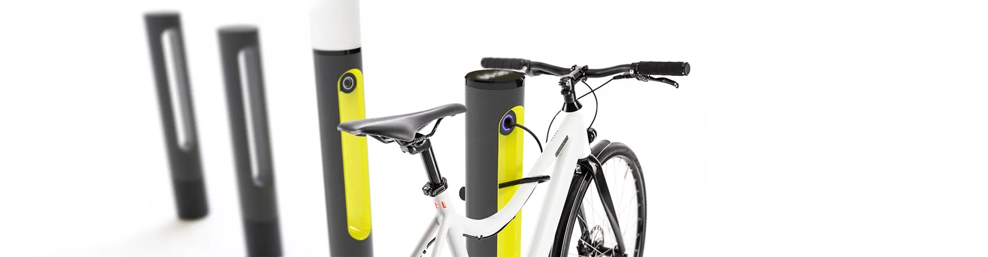 White e-bike locked to a SMARTPOLE charging station with additional base poles in background, wide format