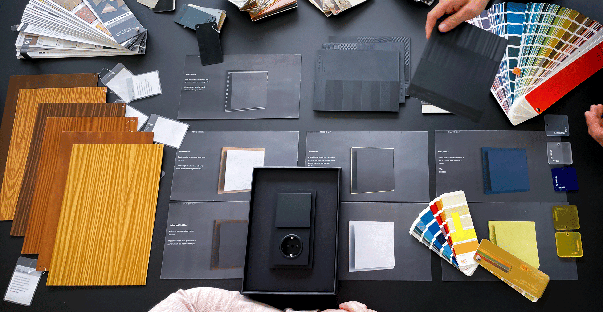 CMF design session for Busch-art linear by Busch-Jaeger — material boards, wood veneers and color swatches on a desk